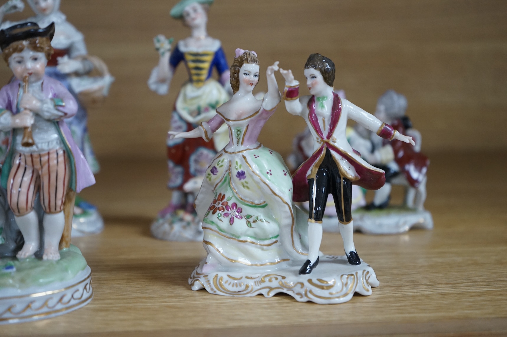 A collection of ten German and English porcelain figures and figure groups, mainly late 19th century, to include Dresden, largest 17cm high